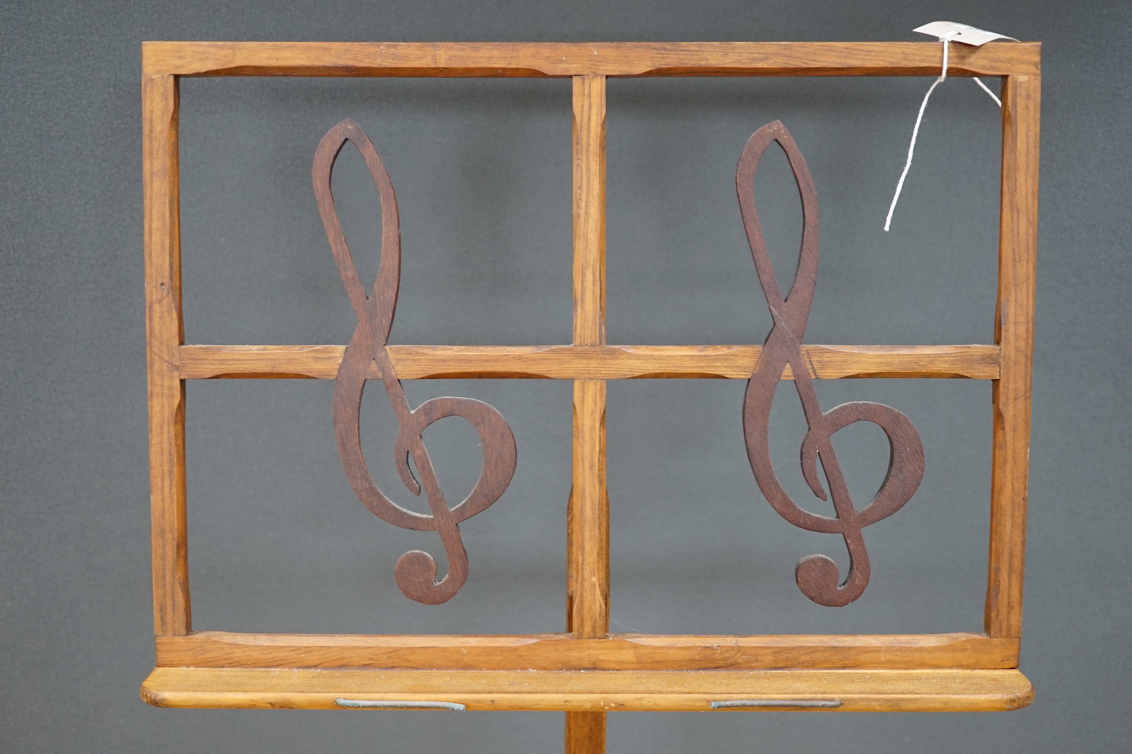 A pine adjustable music stand, with hardwood treble clef decoration